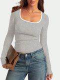 Women's slim fit cotton top with a square collar and long sleeves in a solid colour, showing its short length.