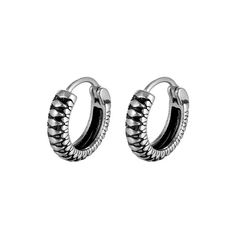Silver geometric alloy earrings with circular stripe design on a white background.