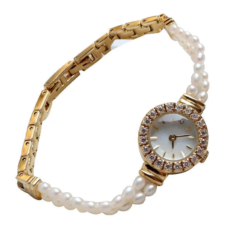 Light gold women's watch with a stainless steel strap featuring integrated freshwater pearls and a round white dial.