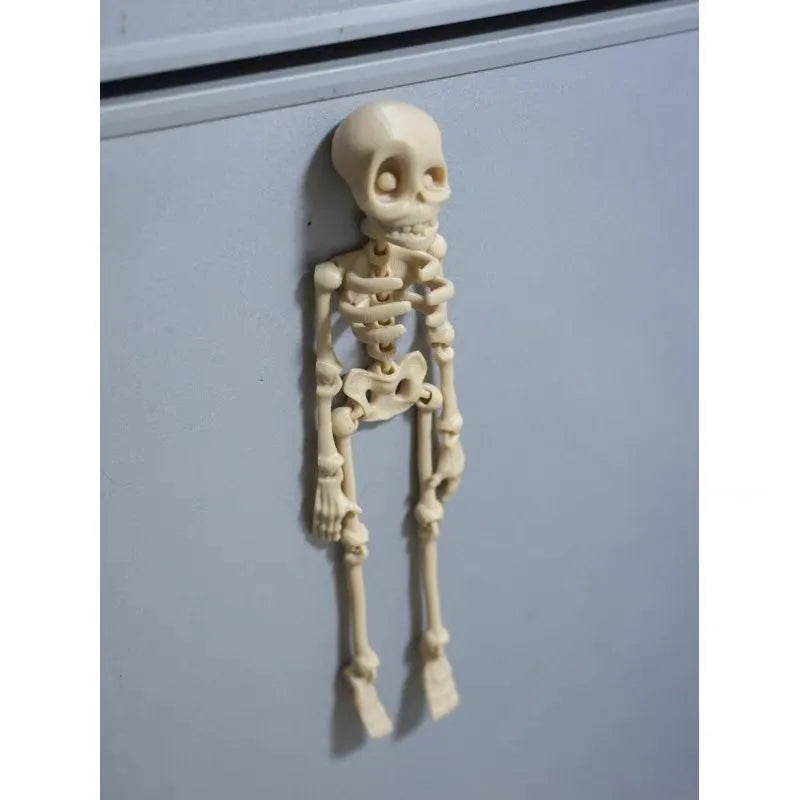 Tall 3D printed white skull ornament with intricate detail placed on a refrigerator door.