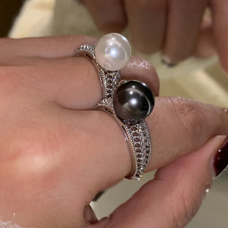 Adjustable open geometric copper ring for women with a small black pearl accent on the band.