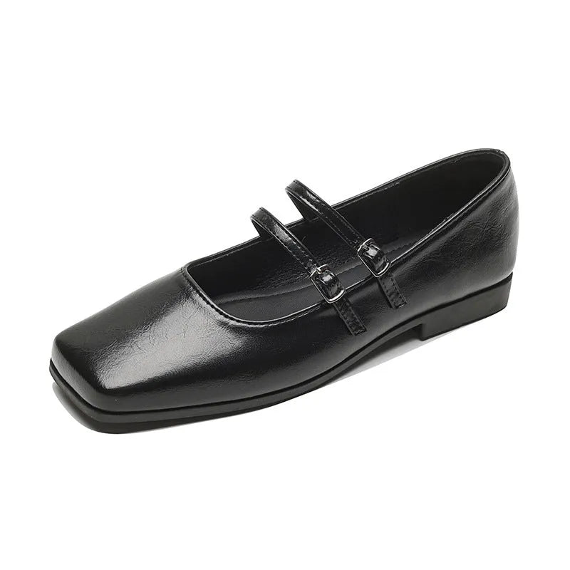Women's silver leather ballet flats with a cross buckle strap and round toe.