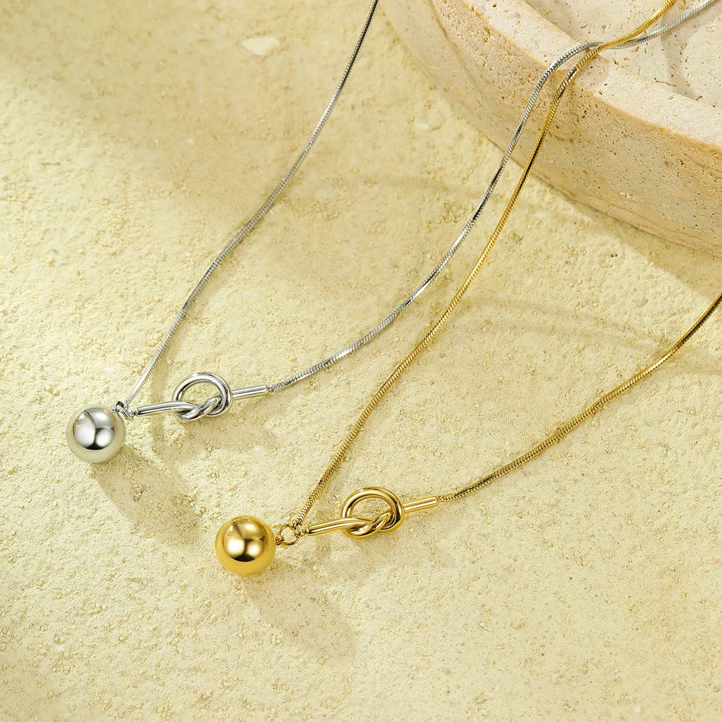 18K gold plated stainless steel winding ball pendant necklace for women on a white background