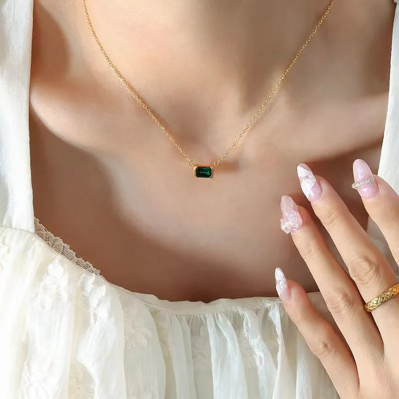 Gold-coloured geometric quadrilateral pendant necklace on a model, showing Lvzuan inlay detail on copper.