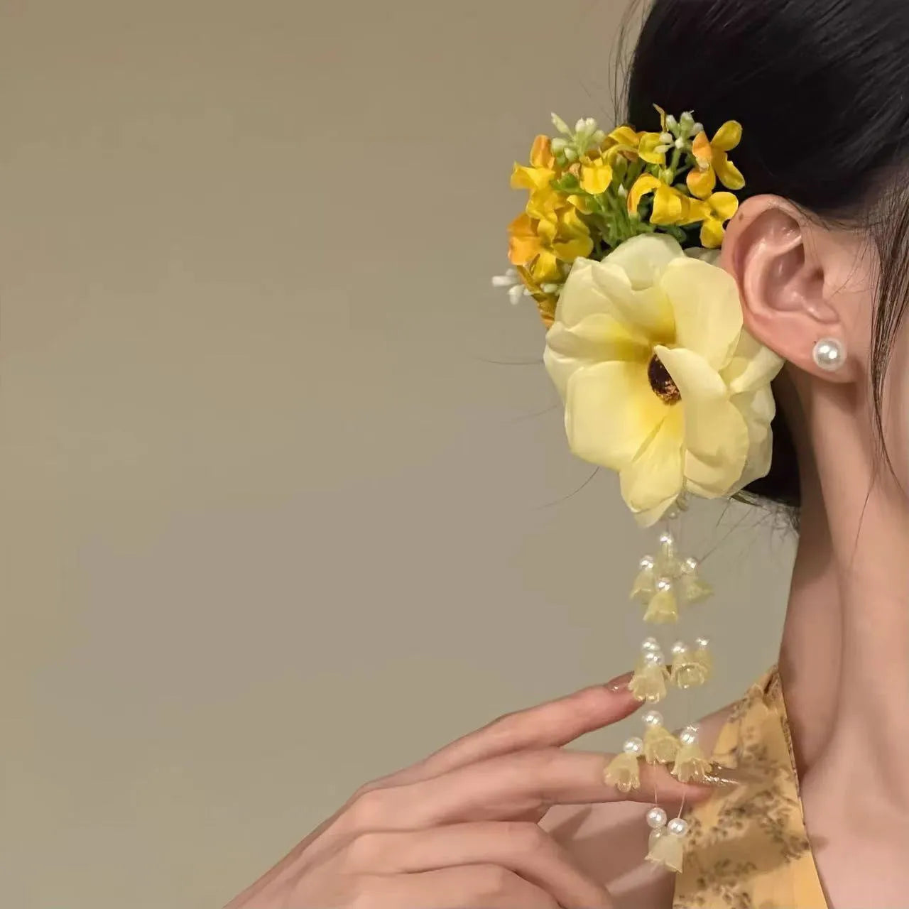 Yellow flower tassel side hair clip on a white background.