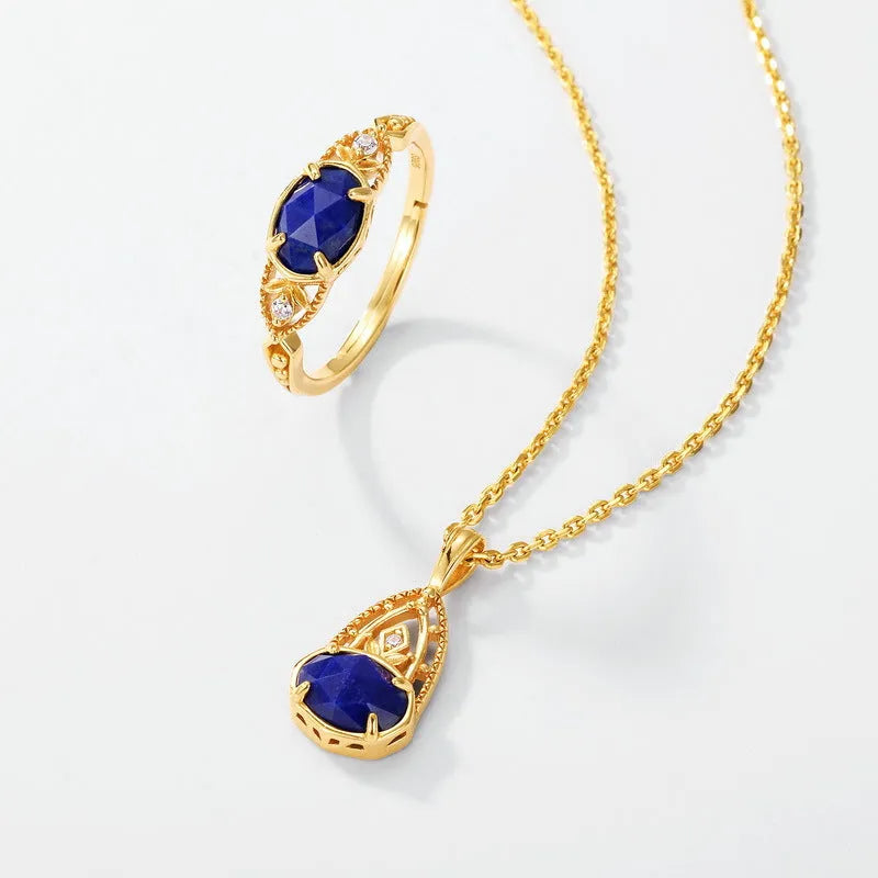 Close-up of a silver alloy ring with an elliptical geometric shape and a central natural lapis lazuli stone.