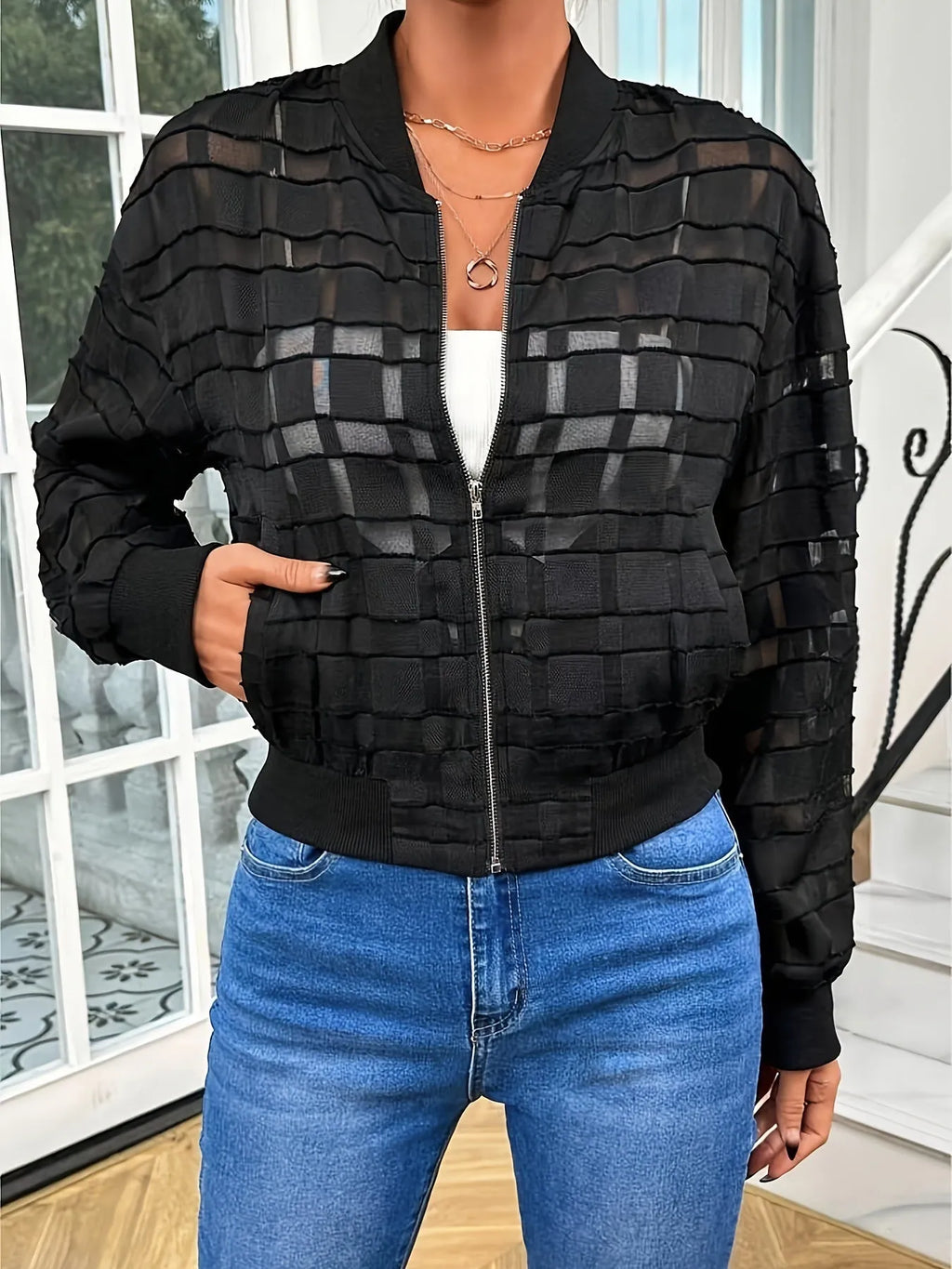 Black women's casual jacket with geometric pattern and semi-transparent thread zipper detail.