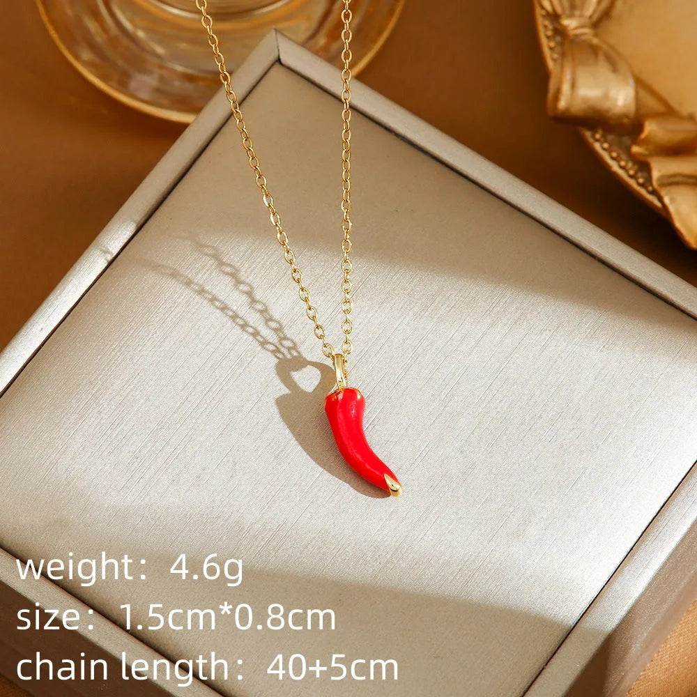 Golden titanium steel necklace with cherry, strawberry, and pepper pendant on O-ring chain.