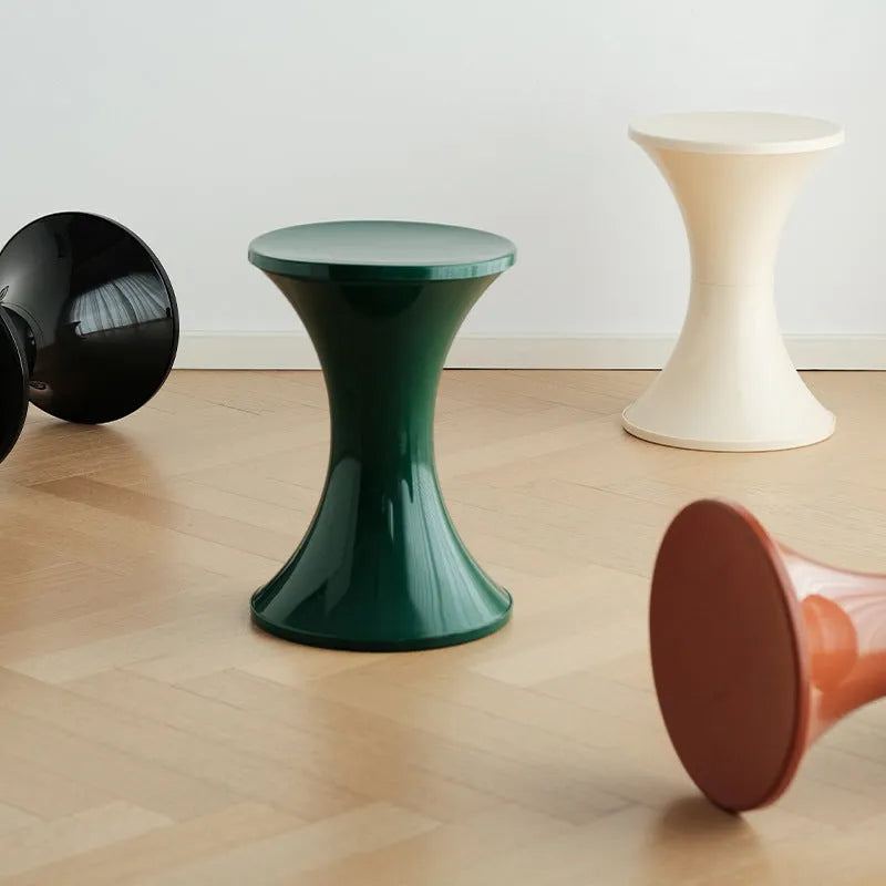 A plastic hourglass-style shoe changing stool shown in one of five available colours: black, green, red, white, or brown.