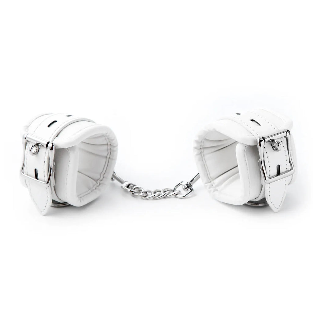 White PU sponge bondage cuffs set showing handcuffs, foot cuffs, and a neck cuff.