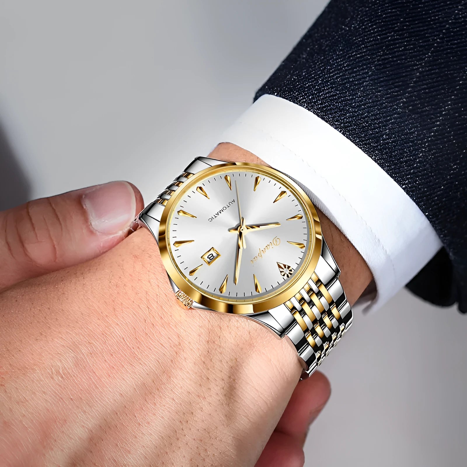 Men's simple dial automatic mechanical watch with stainless steel bracelet on wrist.