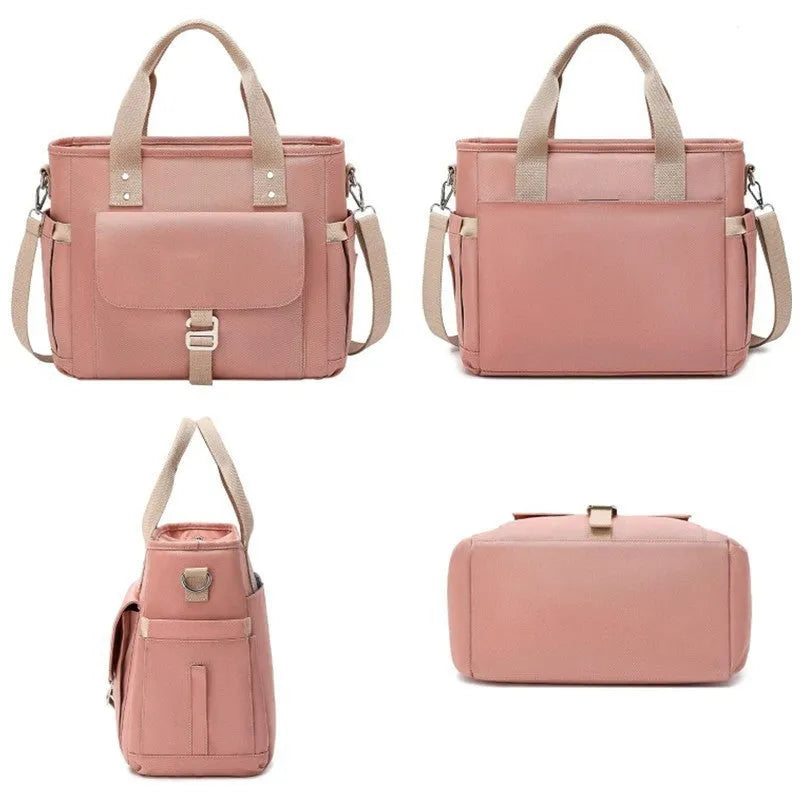 Insulated cube-shaped picnic bag with a removable shoulder strap and a side pocket, shown in pink colour.