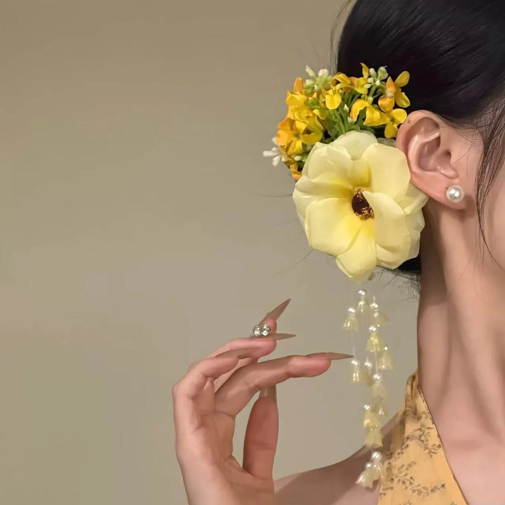 Yellow flower tassel side hair clip on a white background.