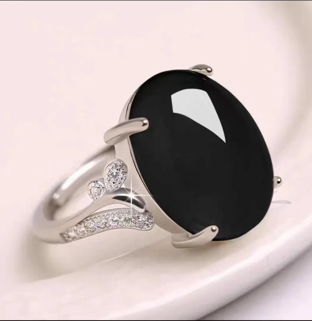 Geometric adjustable alloy ring on a hand, shown in blue finish.