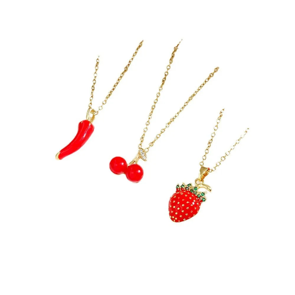Golden titanium steel necklace with cherry, strawberry, and pepper pendant on O-ring chain.