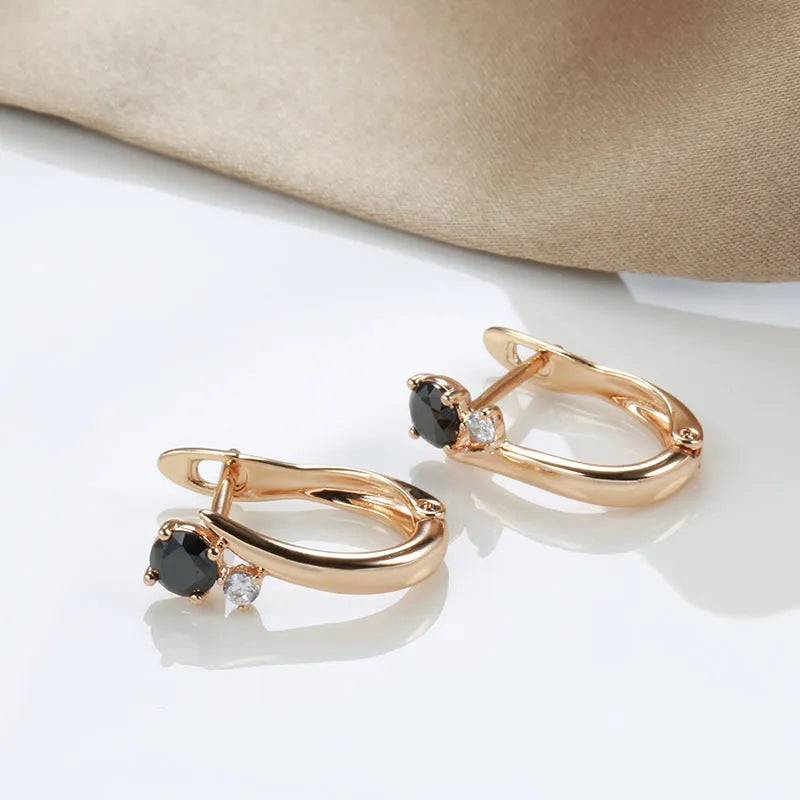 Gold drop earrings with geometric design and black agate stone inlay on copper base