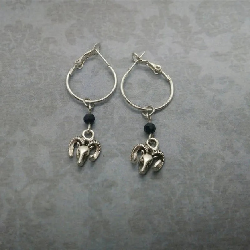 A pair of silver-coloured alloy round ring earrings for women with a Tibetan antelope design influence.