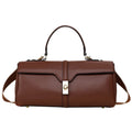 Women's cylindrical black cowhide messenger bag showing internal organiser compartments