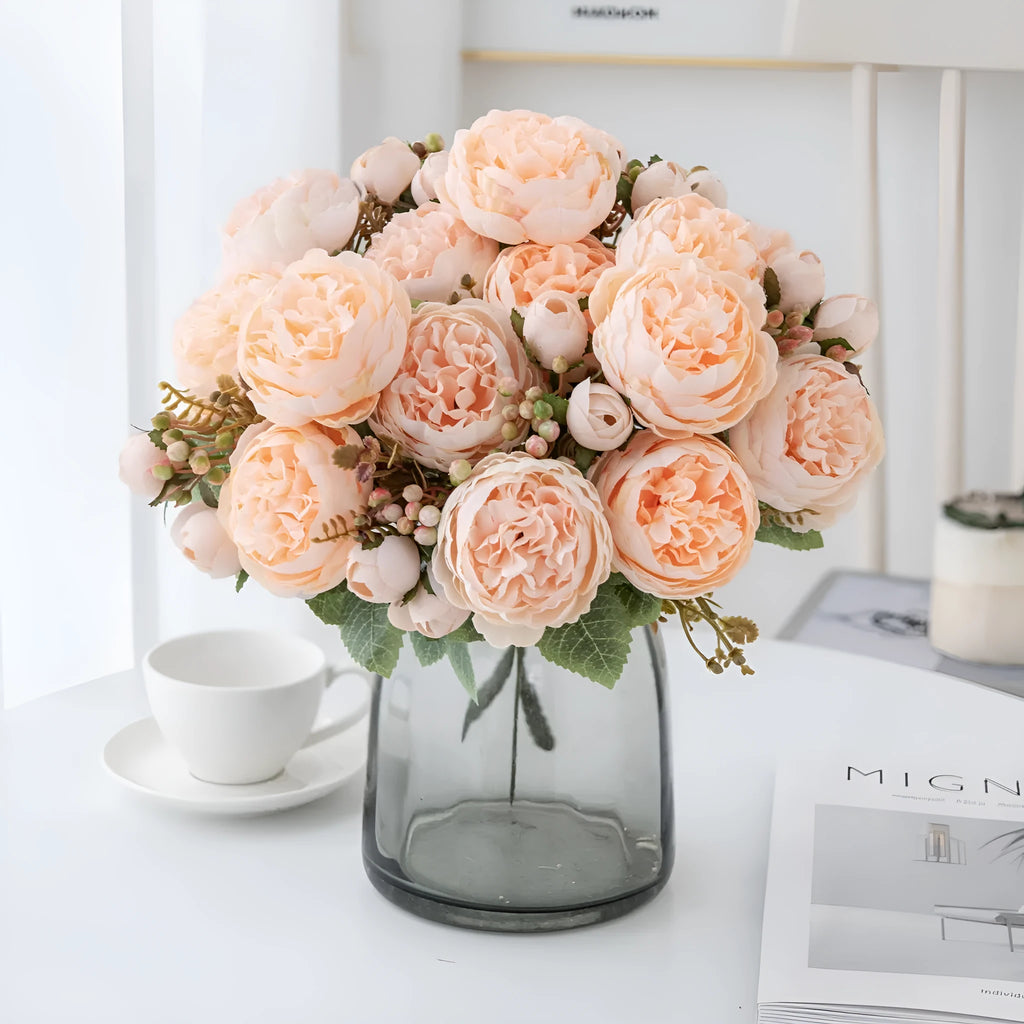 Artificial silk peony bouquet in champagne colour on a table.