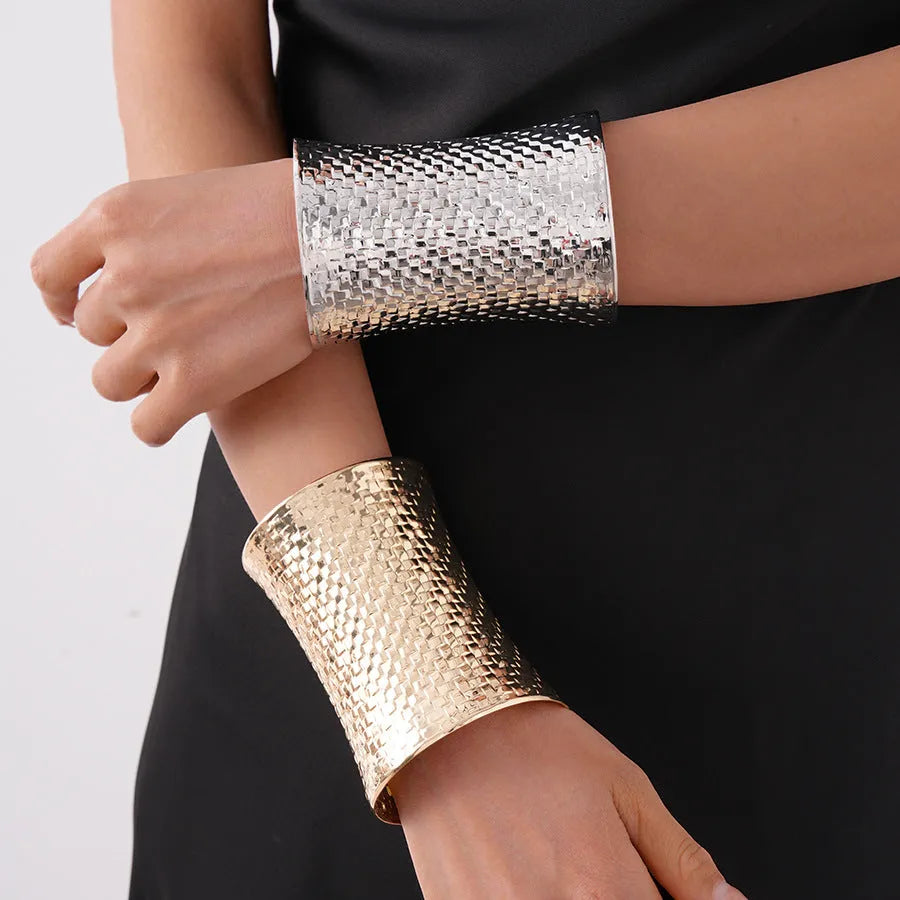 Women's vintage exaggerated metal bracelet in gold or silver colour with round design elements.