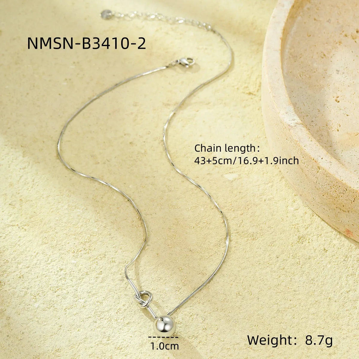 18K gold plated stainless steel winding ball pendant necklace for women on a white background
