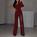 Women's black polyester jumpsuit with an oblique shoulder and a high slit on the leg, featuring long sleeves.