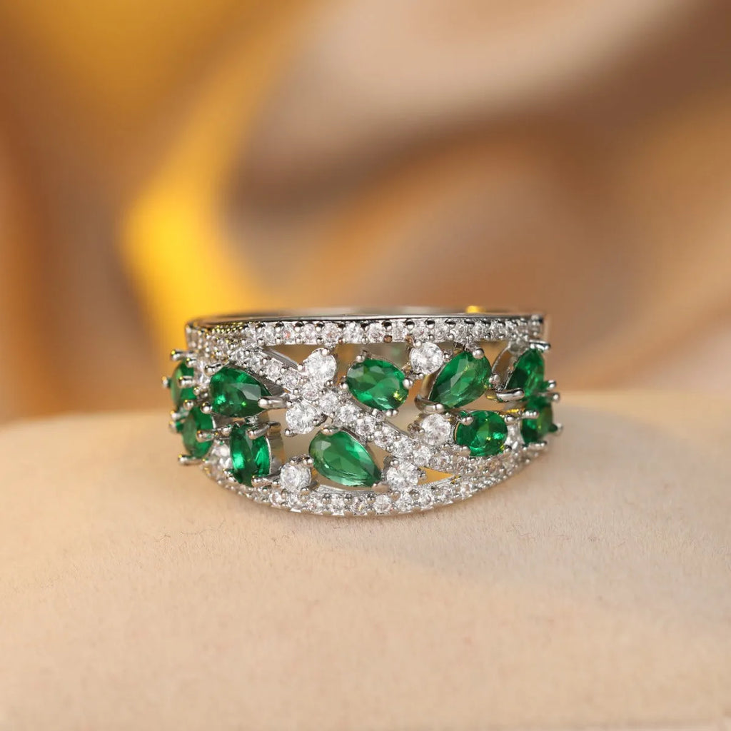 Women's round hollow ring with a gemstone, shown in gold and platinum with blue and white stone options.