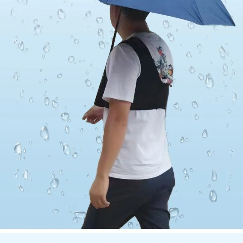 Black portable umbrella shoulder strap holder supporting an open manual folding umbrella.