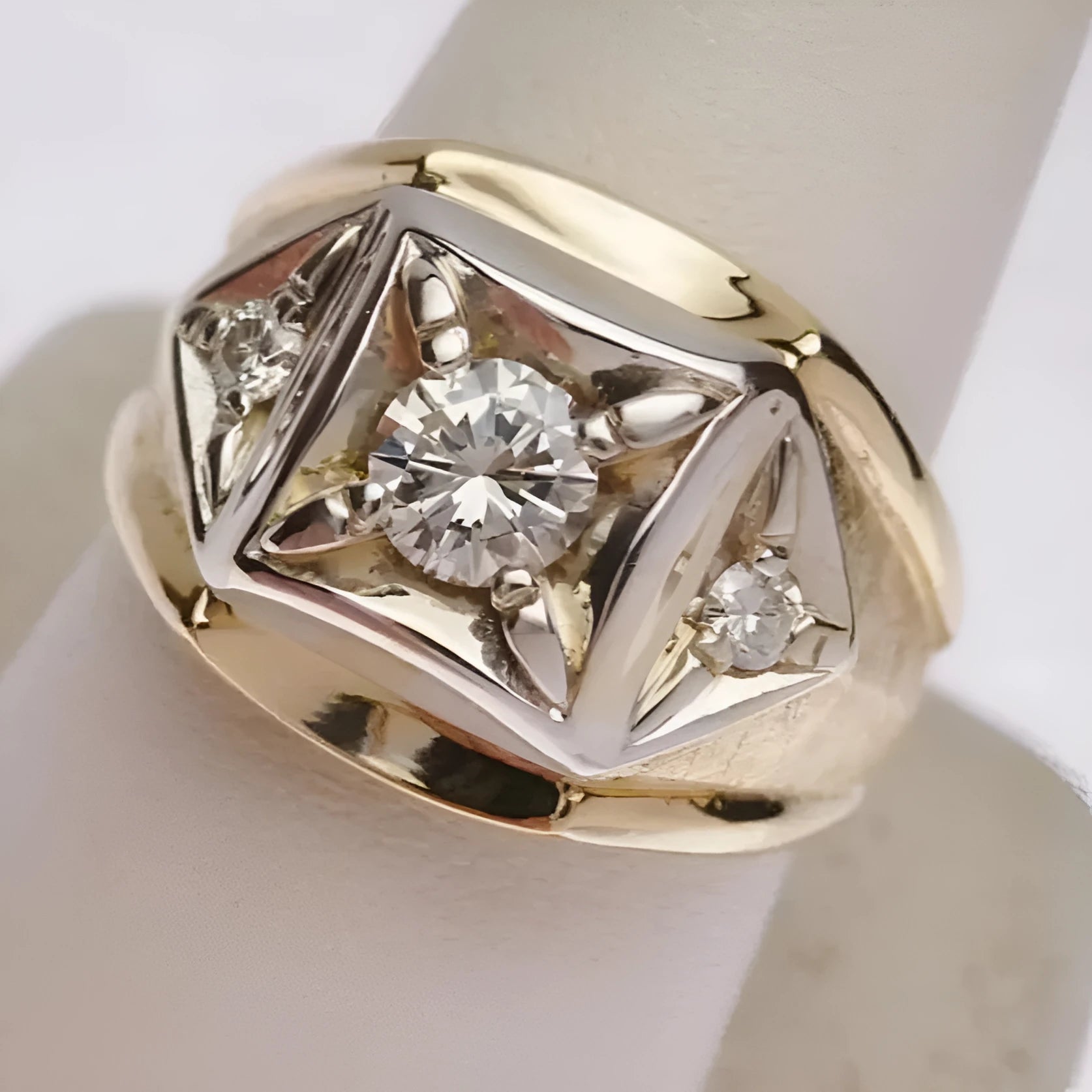 A pair of wide face geometric hollow design couple rings in gold plating on a solid copper base.