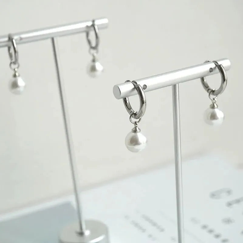 Women's geometric pearl earrings with round elements and titanium steel alloy construction