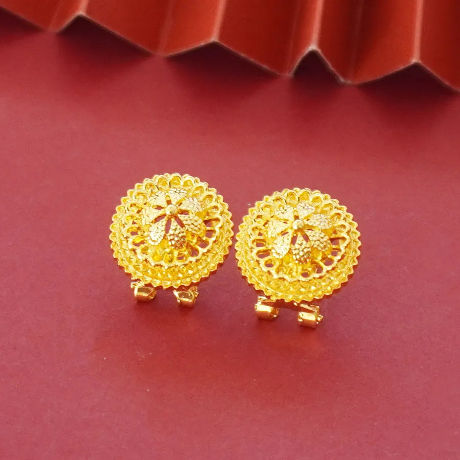 Gold-plated jewellery three-piece set with flower design pendant, matching earrings, and ring on display