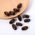 Dark coffee coloured oval wooden bead with M-shape profile, showing 6mm hole.