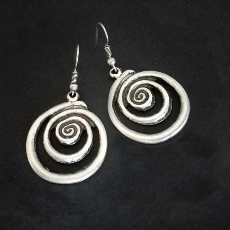 A pair of retro-style geometric spiral earrings with a distressed silver finish.