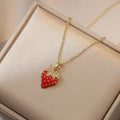 Golden titanium steel necklace with cherry, strawberry, and pepper pendant on O-ring chain.