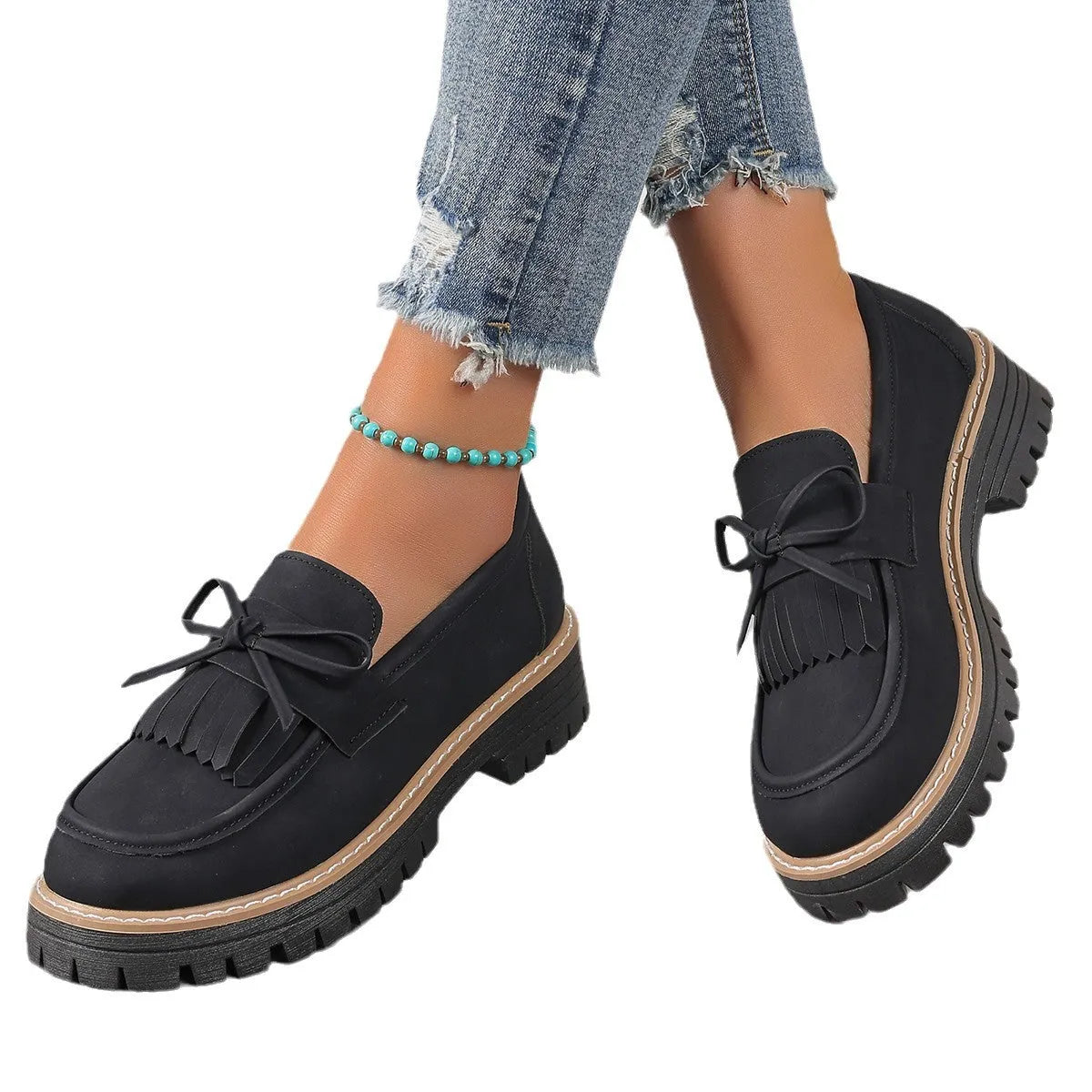 Black plus size women's loafers with tassel detail, bowknot, and a chunky low heel.