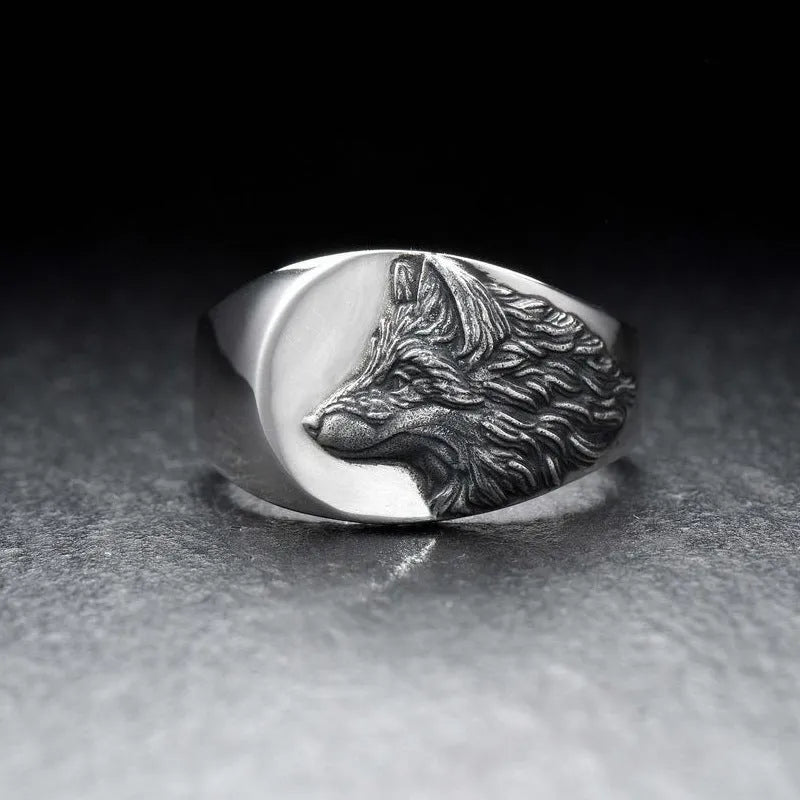 Men's silver geometric wolf head signet ring on a black background, showing its retro-inspired alloy design.