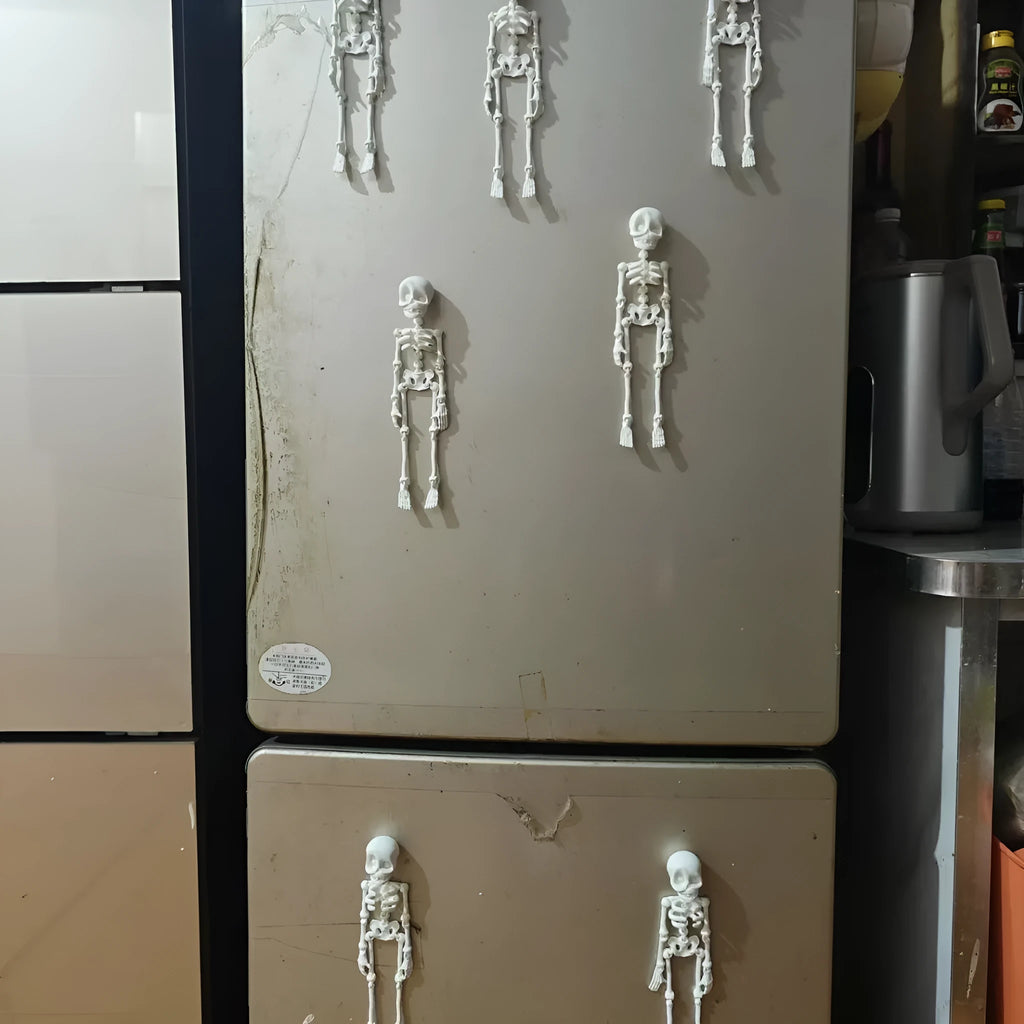 Tall 3D printed white skull ornament with intricate detail placed on a refrigerator door.