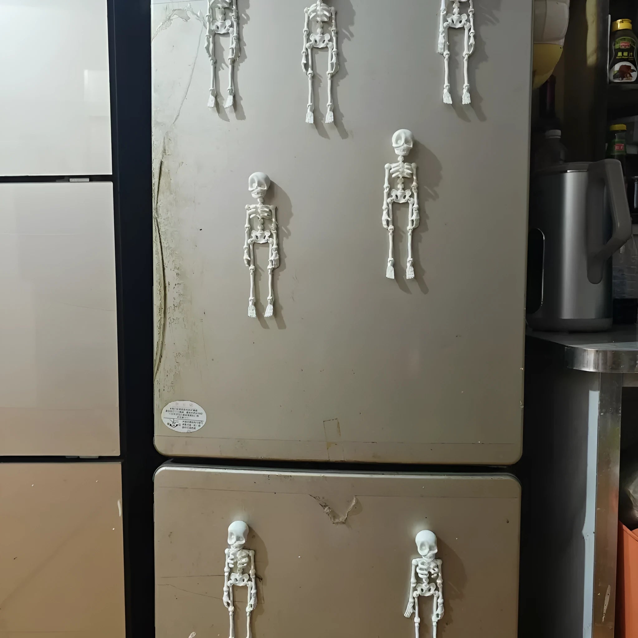 Tall 3D printed white skull ornament with intricate detail placed on a refrigerator door.