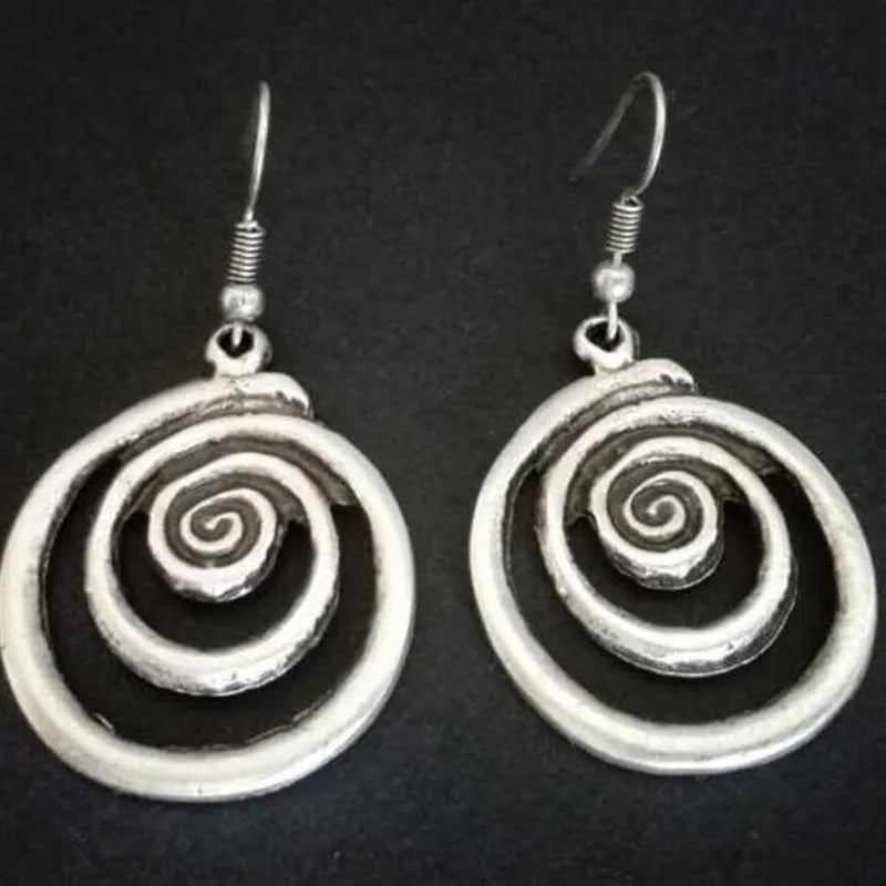 A pair of retro-style geometric spiral earrings with a distressed silver finish.