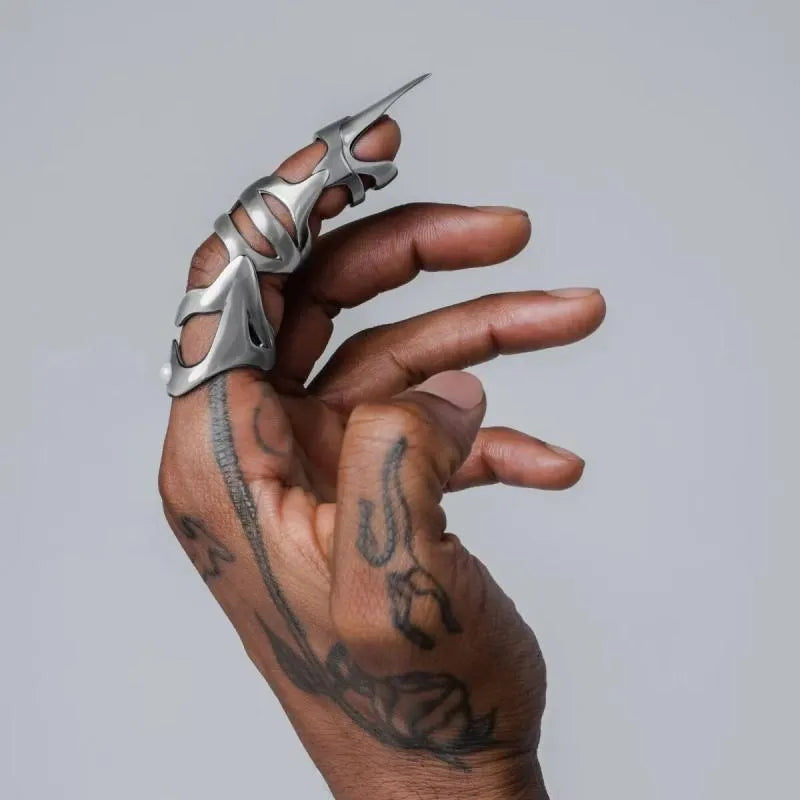 Silver-coloured punk armour finger stall fashion ring made from alloy.
