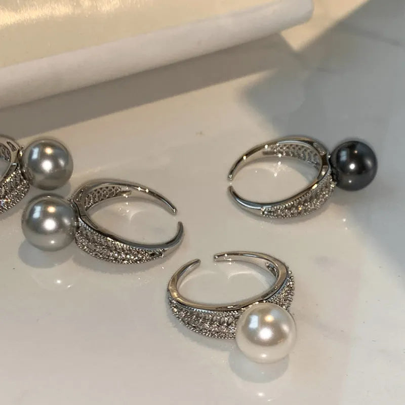Adjustable open geometric copper ring for women with a small black pearl accent on the band.