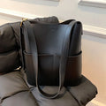 Large capacity PU shoulder bag in black with decorative seaming and sandwich pocket