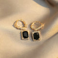 Pair of black geometric French court earrings with zircon stones on copper.