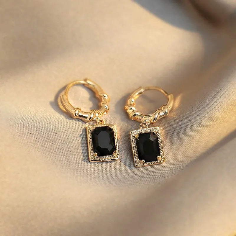 Pair of black geometric French court earrings with zircon stones on copper.