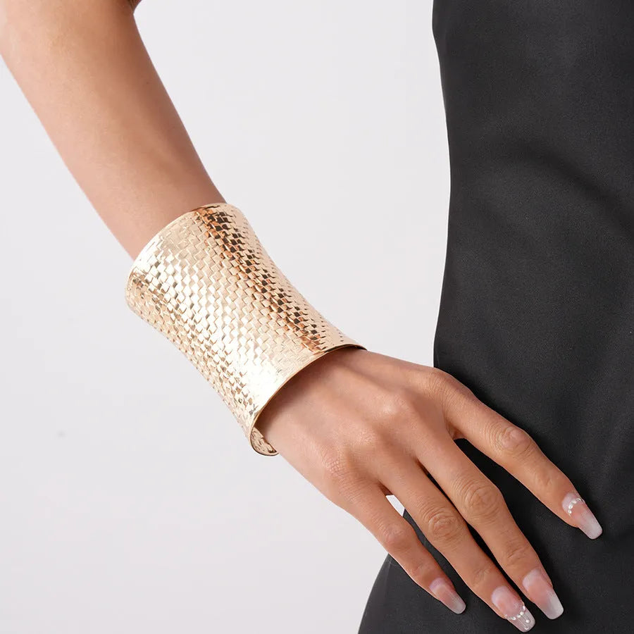 Women's vintage exaggerated metal bracelet in gold or silver colour with round design elements.