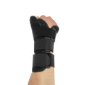 Black carbon fibre sports wrist guard with grey edging and an adjustable thumb strap laid flat.
