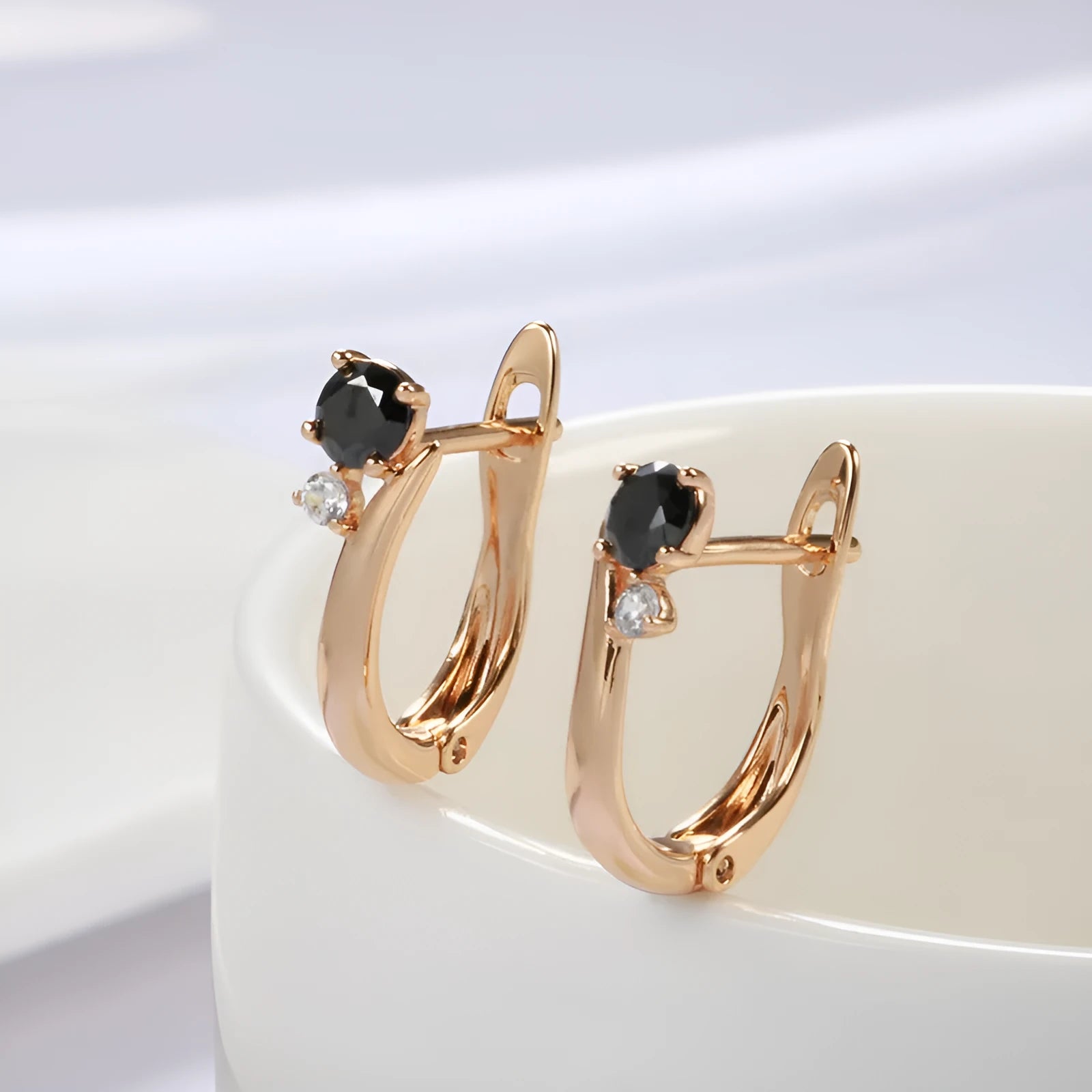 Gold drop earrings with geometric design and black agate stone inlay on copper base