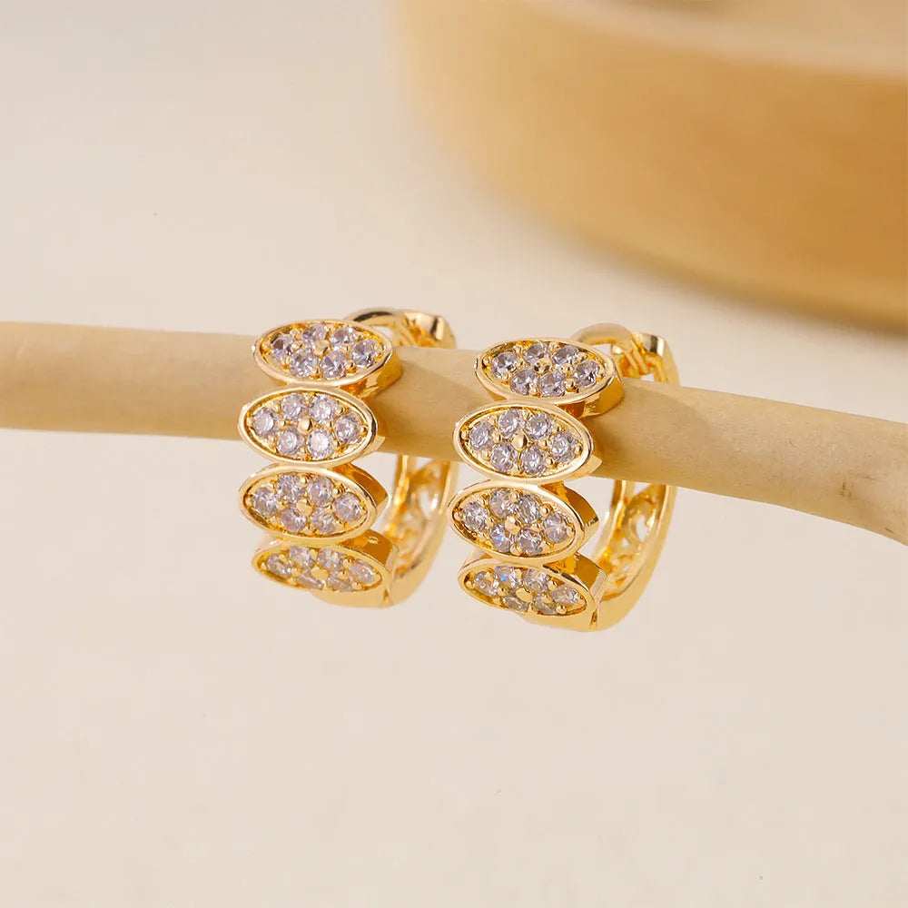 Gold women's earrings with zircon gemstones and stud fastenings