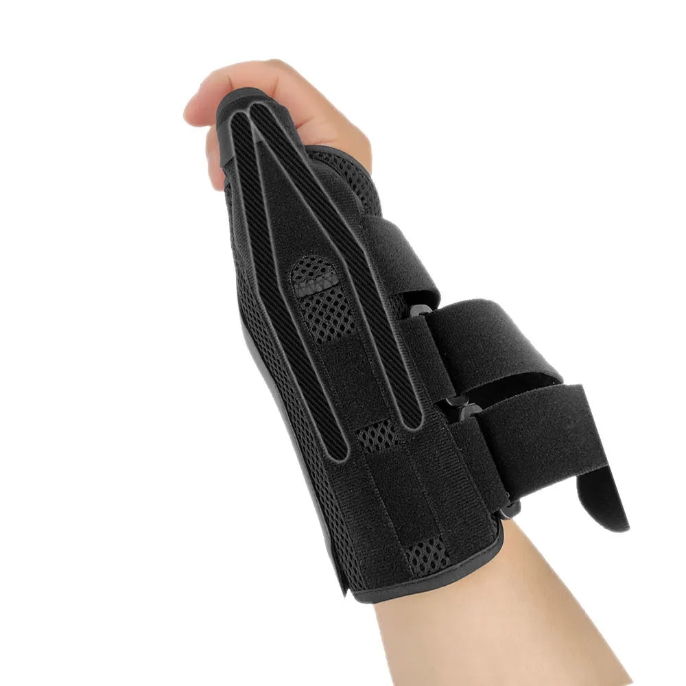 Black carbon fibre sports wrist guard with grey edging and an adjustable thumb strap laid flat.