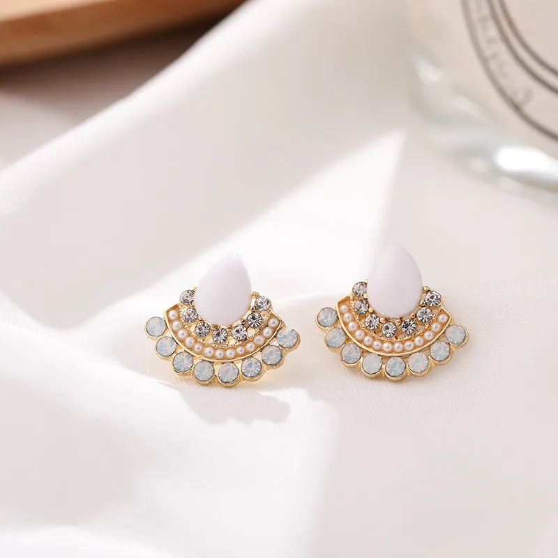 Women's silver retro fan-shaped earrings with opal and rhinestone details on a white background.